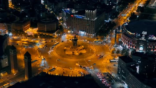 Aerial drone view of Plaza of Spain in Barcelona at evening, Spain. Roundabout with moving cars, bui