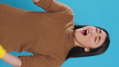 Woman Yawns Covering Mouth With Cleaning Glove