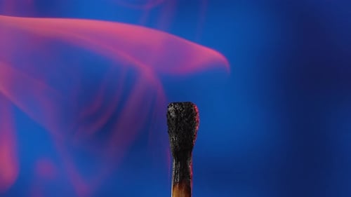 Burning Matchstick Flame and Smoke on Blue