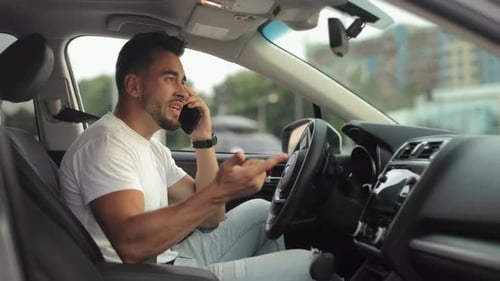 Man Talking on Phone in Car, Frustrated