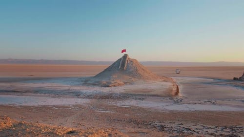 Desert Landscape with Flag at Sunrise or Sunset
