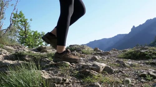 View on Feet of Traveler Woman Hiking Walking on the Top of Cliff in Mountain Walking on Rocks