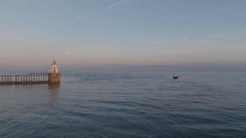 Evening Glow at Blyth Lighthouse as a vessel enters the harbour.