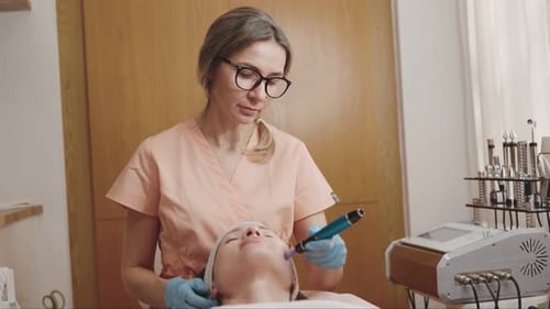 Cosmetic Surgeon Performing Procedure on Lying Woman