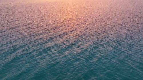 Bei Sonnenuntergang über den Ozean fliegen. Luftaufnahme des Drohnenfluges über das Meer bei Sonnenuntergang.