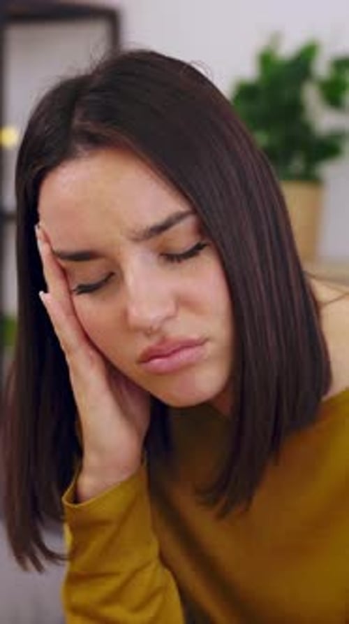Woman with a Painful Headache Indoors