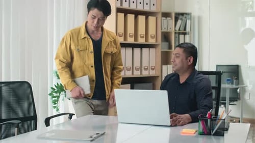 Sales Manager Greeting Director and Shaking Hands at Office