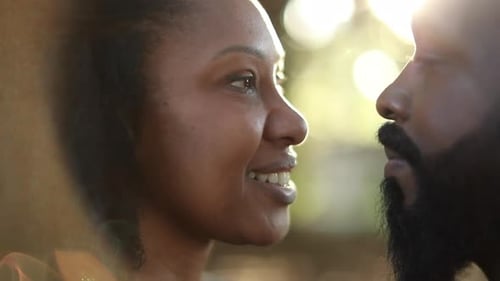 African couple staring at each other outside in park nature