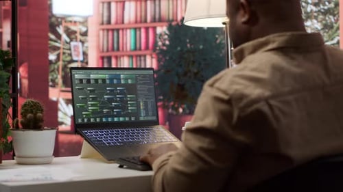 Adult Working on Laptop in Home Office