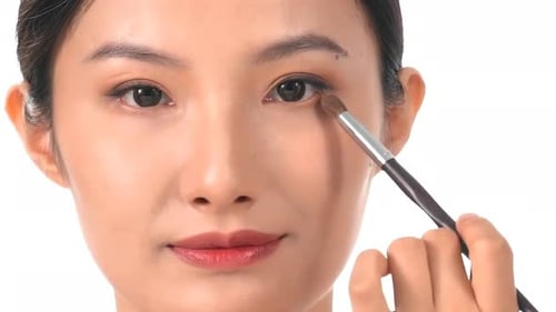 Young Adult Applying Eye Shadow With Brush