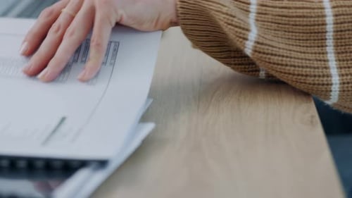 Hands, writing and reading notes on desk for research information while working and learning