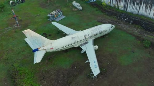 Aerial view of abandoned plane in grassy field, Indonesia.