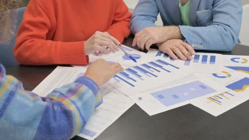 Business Team Discussing Charts and Graphs