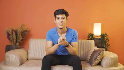 Man looking at camera making confidence sign.