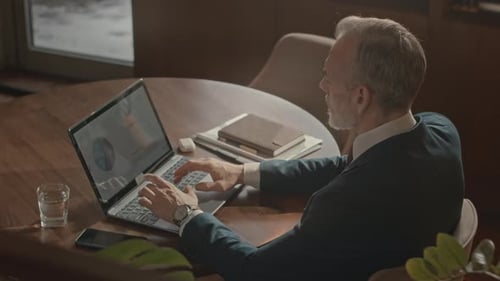Senior Businessman Working on Laptop in Office