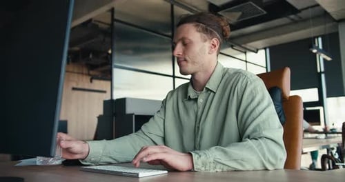 Productivity Refueled GreenShirted Professional Balancing Work and Hydration in the Office
