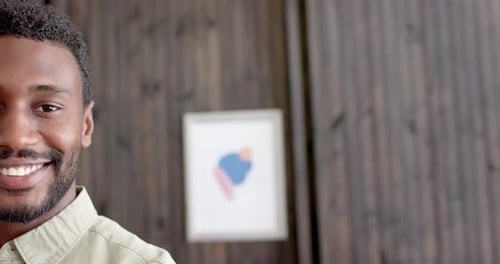 Portrait of happy african american businessman in office in slow motion