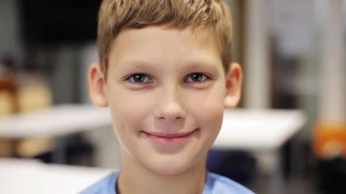 Smiling Boy Close Up in Classroom Setting