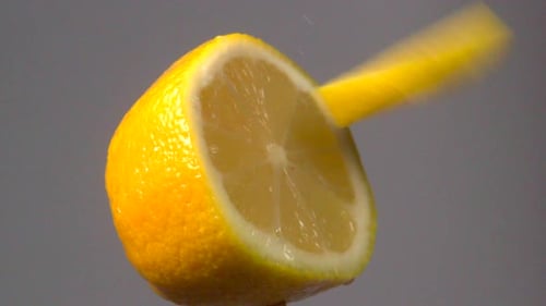 Cutting Slices From a Half Lemon Close Up