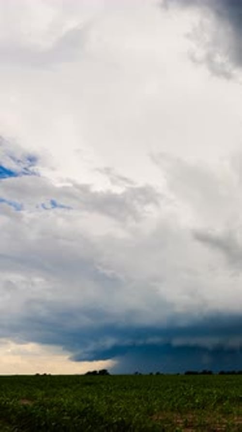 Storm Clouds Looming Over a Green Field