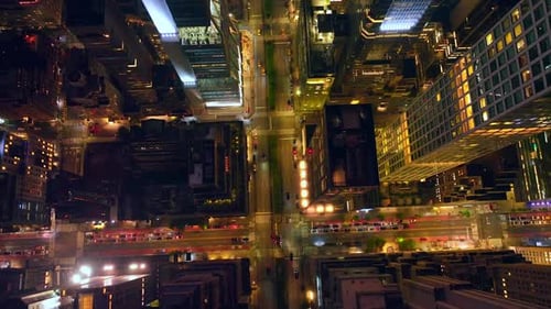 Wide roads crossing outlining beautiful buildings. Wonderful urban city filled with light at night.