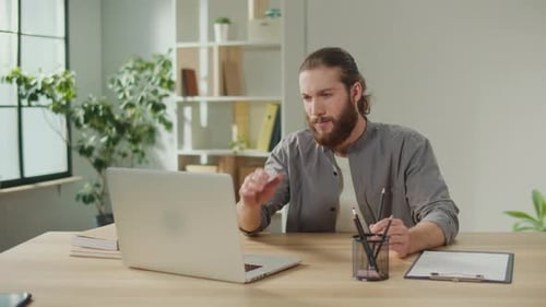 Man Working at Desk Gets Headache