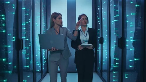 Women Walking Through Data Center Talking Business