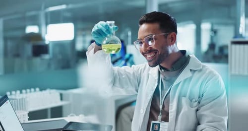 Smiling Scientist Examines Flask in Bright Laboratory