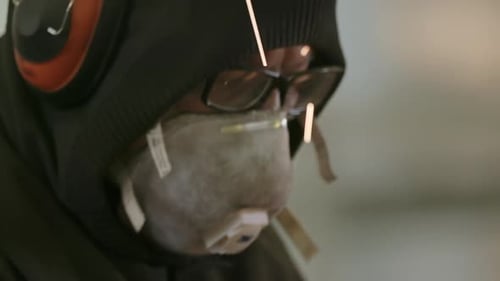 Man Working With Metal Wearing Safety Gear