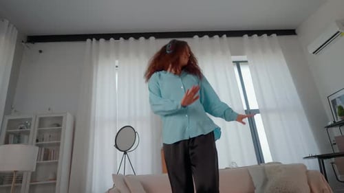 Woman Dancing Energetically at Home