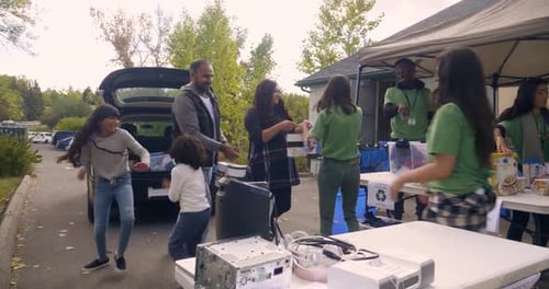 Family Donates Food at Community Food Drive Event