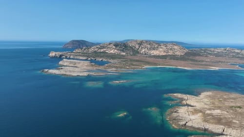 Drone view of the sea coast. Rocky shore and sea water. Vacation and travel.