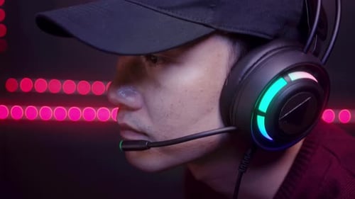 Young male professional Streamer and gamer with headset playing online