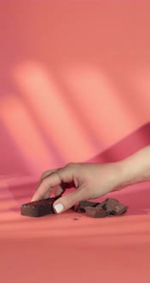 Hand Takes Protein Bar from Surface