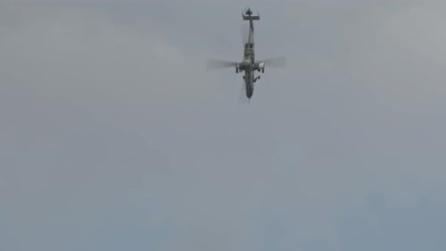 Military Helicopter Flying Through Cloudy Sky