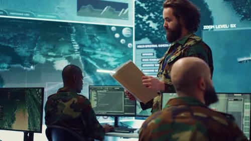 Army Major Reads Operation Details From a Case File in a Control Center