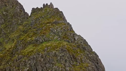 Drone View Of Eystrahorn Mountain's Rocky And Grassy Slope