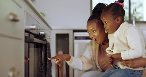 Adult and Child Cooking Together in the Kitchen