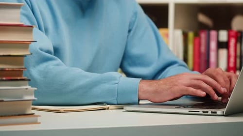 Man Reading Book in University Library Book Shop or Store Spanish Student Wearing Glasses Standing