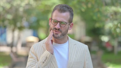 Man with Toothache Touching His Face