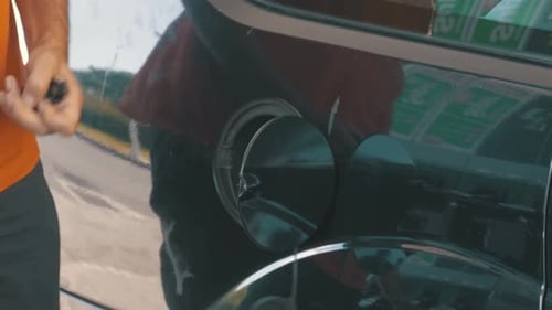 Man Filling Car with Gas Man's Hand Using a Petrol Pump to Fill His Car Up with Fuel
