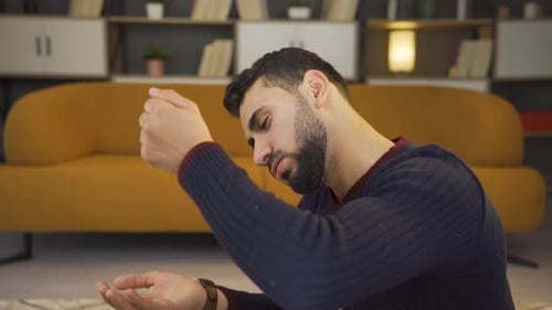 Man Drops Pills Into Hand Inside Home