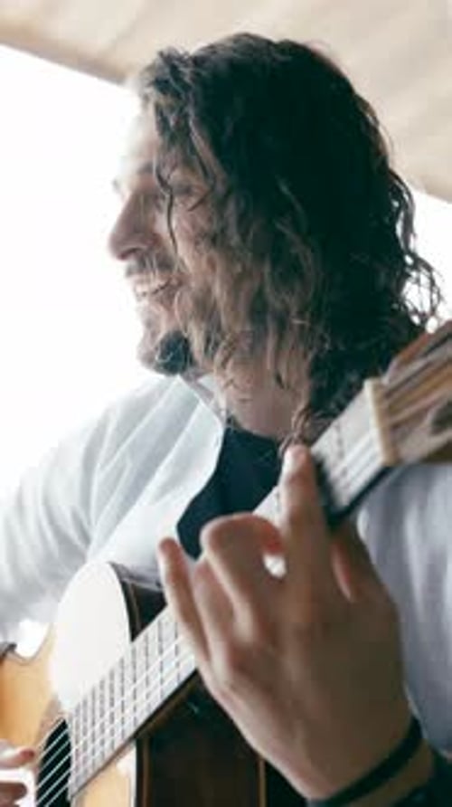 Passionate Handsome Man Playing Acoustic Guitar and Singing