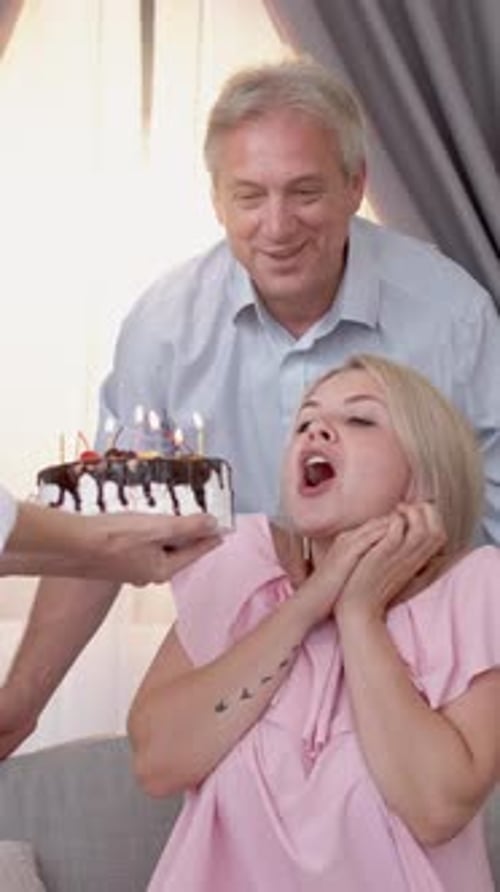 Affectionate Couple Celebrates Birthday with Cake and Hugs