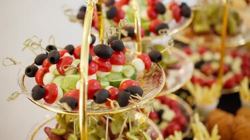 Parallax shot of elegant appetizers and canapés on a catering buffet table.
