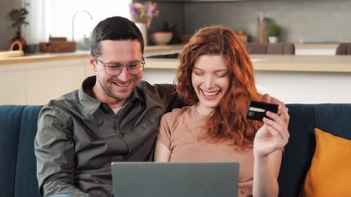 Couple Online Shopping with Laptop and Credit Card