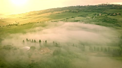Flying over the foggy Tuscany Italy landscape