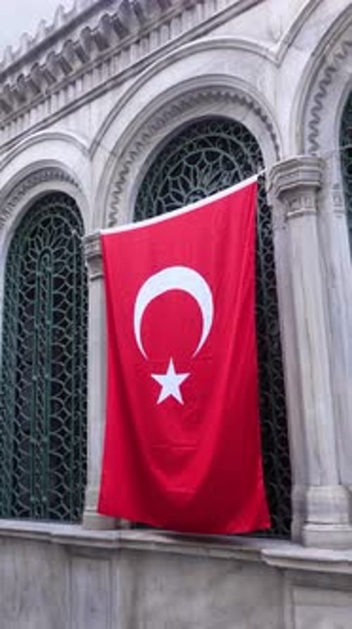 Turkish Flag Hanging on Building with Archways