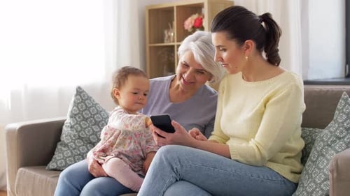Baby, Woman, and Senior Woman Looking at Phone