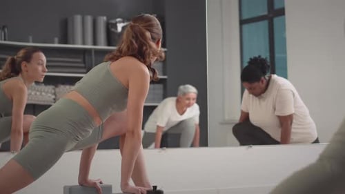 Diverse Women Having Group Stretching Workout in Studio